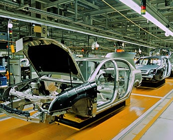 cars getting made in a factory assembly line