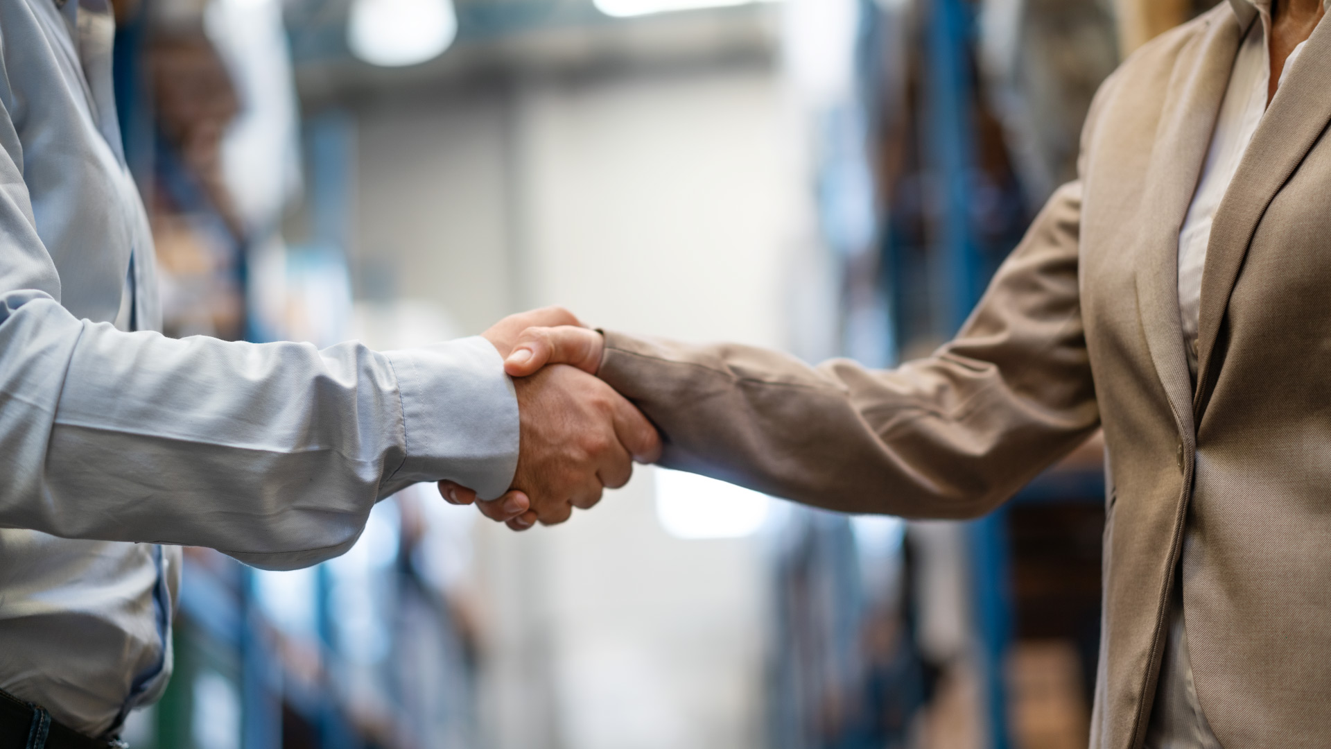 Shaking hands in a warehouse