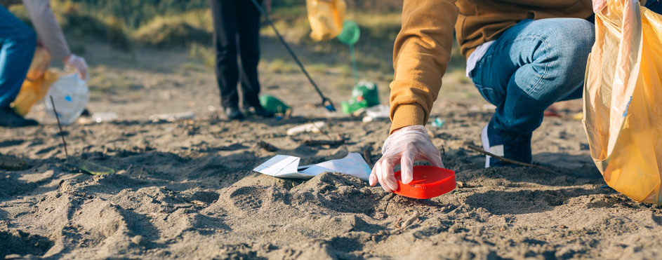 team removes waste from a beach