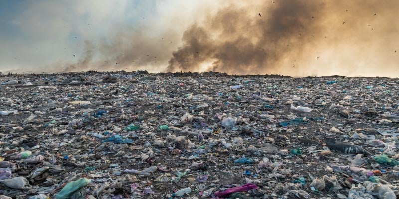 a landfill of garbage and black smoke